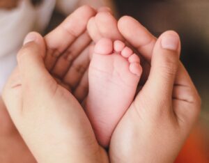 hand holds infant foot